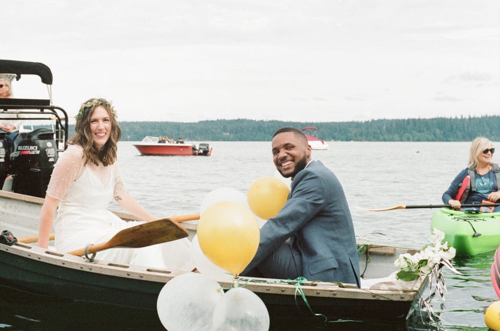 Bride and Groom on their "Just Married" rowboat for their Water's Edge Wedding