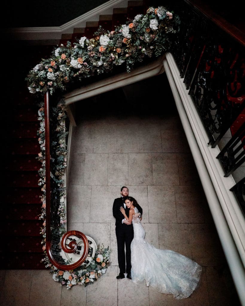 Playful photo concept of bride and groom on floor.