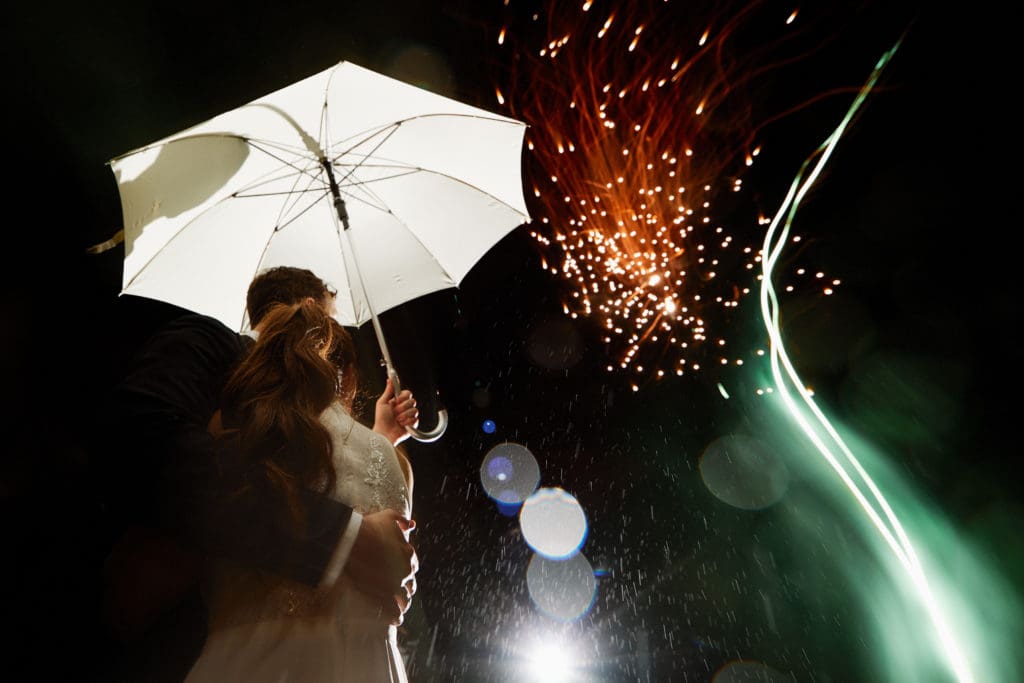 bride and groom wrap up day with fireworks for a timeless wedding portrait.