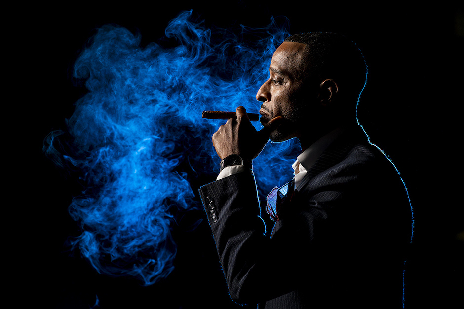 A blue gel added a pop of color to this groom's cigar and smoke from it.