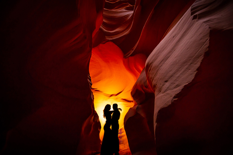 a silhouette of a couple can also be made with a burst of light on a flat wall and off-camera flash.