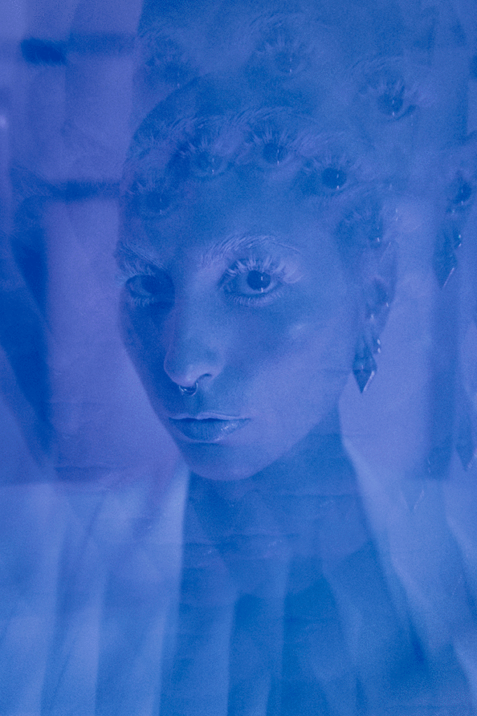 A kaleidoscope filter on this image of a woman adds a disorienting effect on a dramatic portrait.