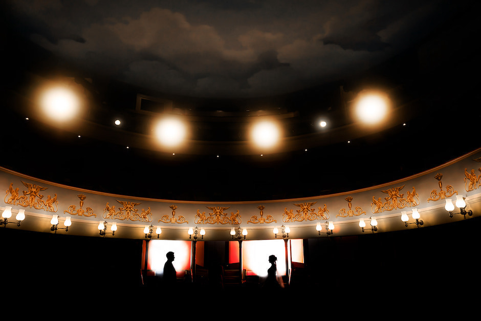 color version of bride and groom in dark venue.