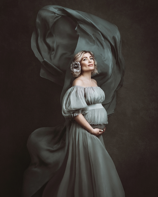 The maternity image of a woman in a green dress is among the winners of the 2022 WPPI award.