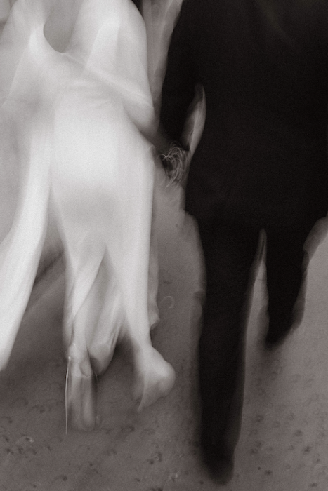 bride and groom walk away with blur effect for movement