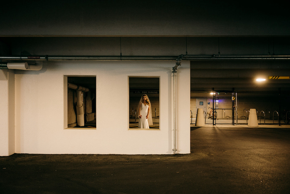 bride in window of parking garage.