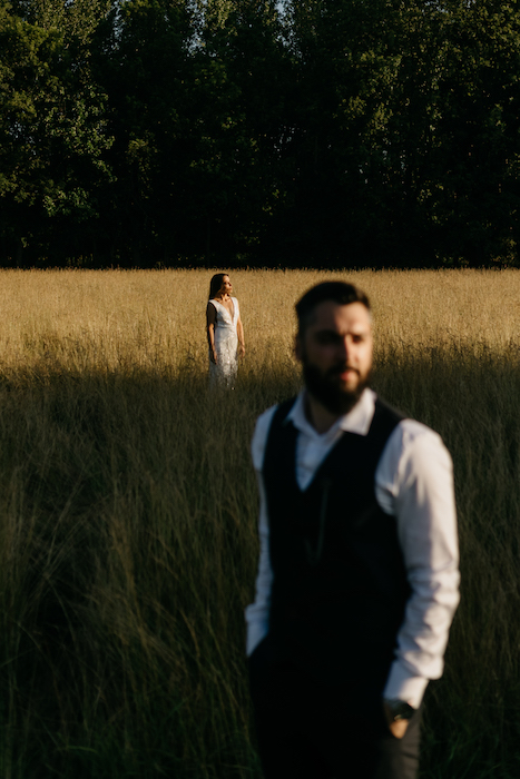wedding portrait of bride and groom in field.