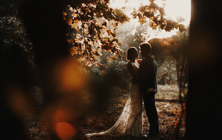 forest portrait of bride and groom with lens flare.