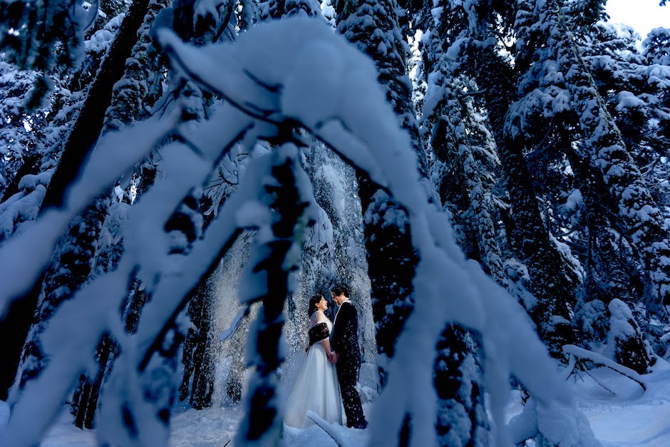 bride and broom in snowy forest.