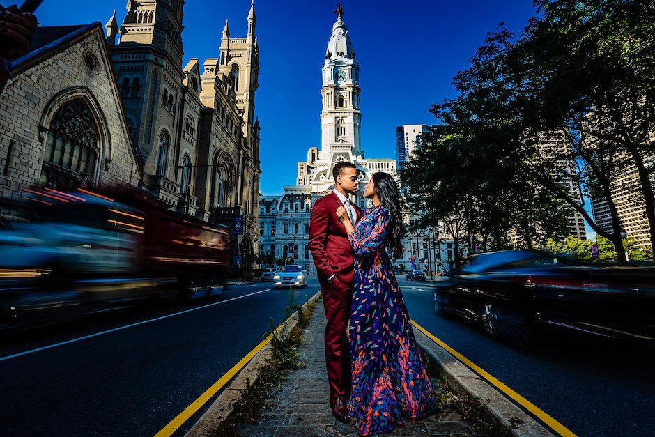 bride and groom in front of city architecture.