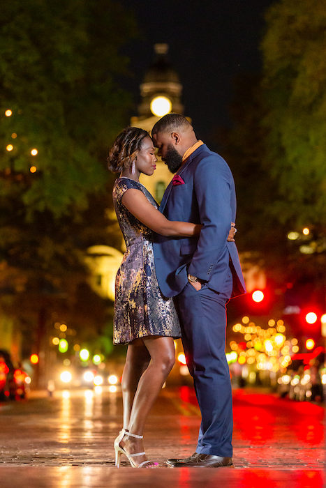 couple touching heads in city portrait.
