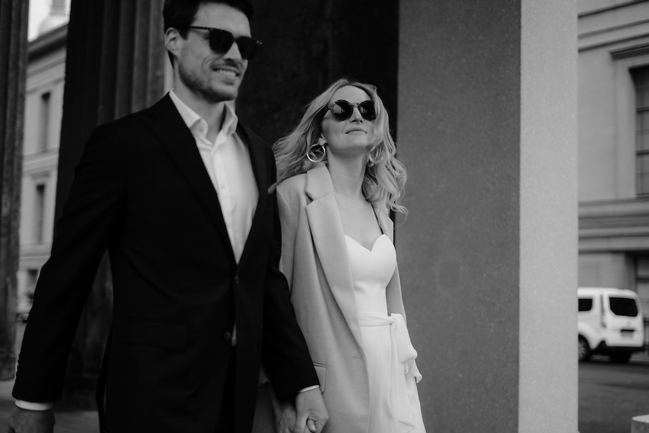 bride and groom walking down city street.