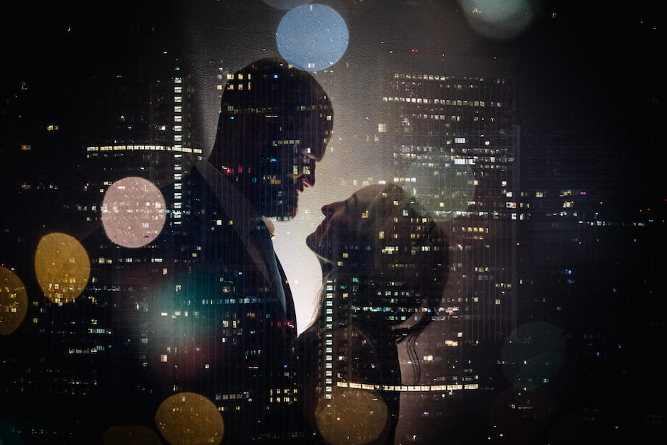 multiple exposure of bride and groom over city architecture.