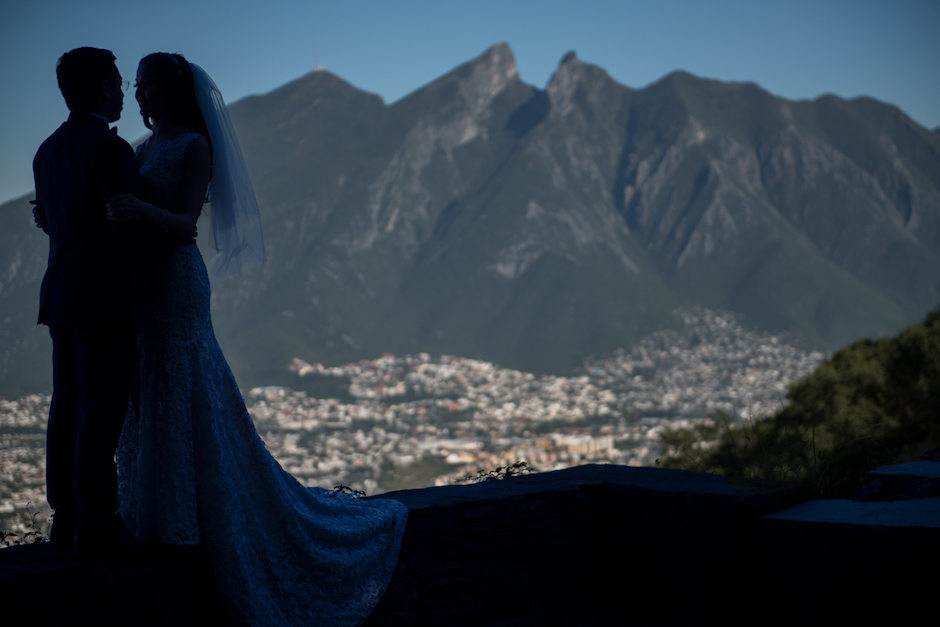 bride and groom with mountain landscape behind them.