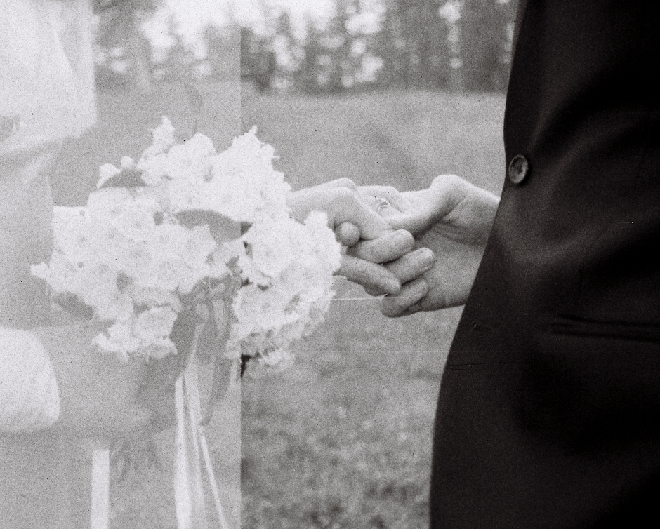 Analog Wedding example of bride and groom holding hands.
