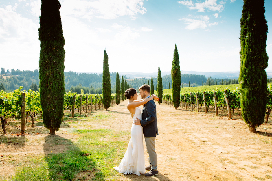 Jessica Hill on easy breezy posing for wedding couple in vineyard.