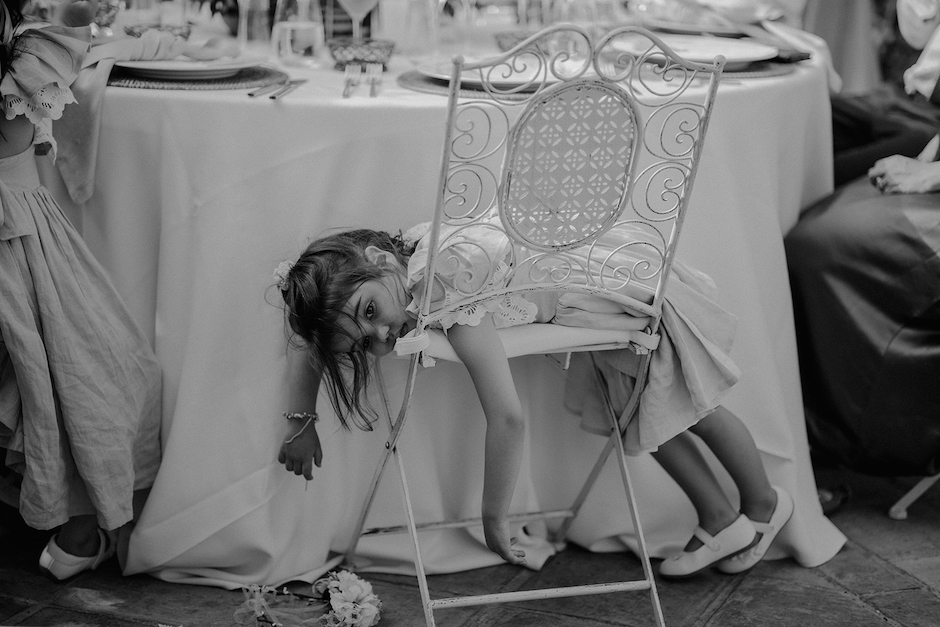 flower girl on chair at wedding